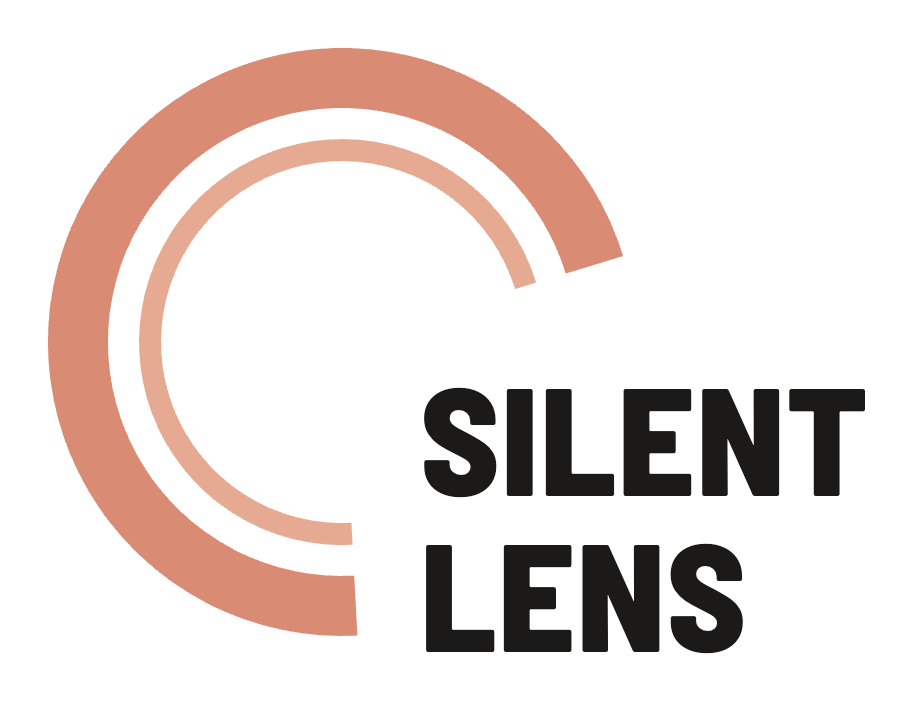 The Silent Lens logo: two large concentric terracotta rings forming a camera lens, with the wordmark SILENT over LENS in heavy dark-ink condensed type set at the lower right.