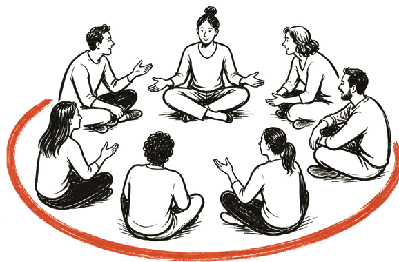 A circle of people sitting on the floor in conversation